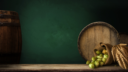 background of barrel and worn old table of woodの写真素材