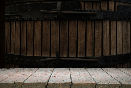 background of barrel and worn old table of woodの写真素材