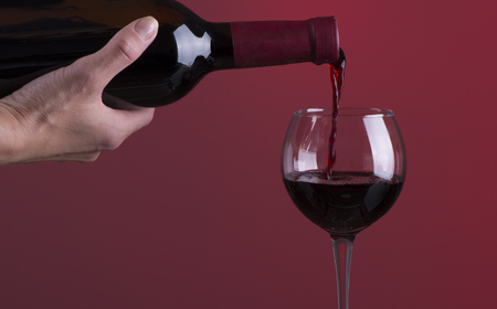 Red wine. Glass of wine. Pouring red wine.の写真素材