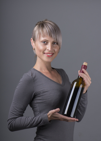 Closeup portrait of young female customer drinking red wine with eyes closedの写真素材