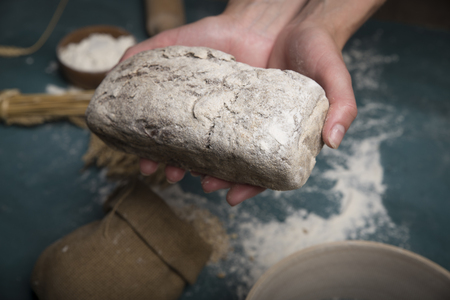 Bread border on wood with copy space background. Brown and white whole grain loaves still life composition with wheat ears scattered around. Bakery and grocery food store concept.の写真素材