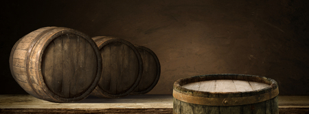 corkscrew and wooden barrel, vineyard on background.の写真素材