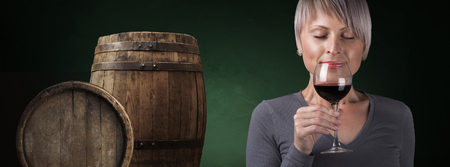 Outdoors portrait of a beautiful wine tasting tourist woman.の写真素材