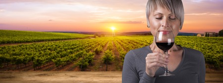 Outdoors portrait of a beautiful wine tasting tourist woman.の写真素材