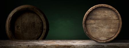 background of barrel and worn old table of wood.の写真素材