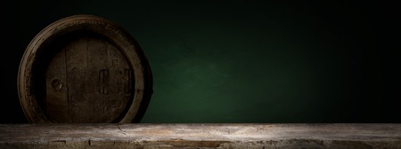 background of barrel and worn old table of wood.の写真素材
