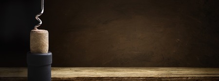 Bottle of wine with corkscrew on wooden backgroundの写真素材