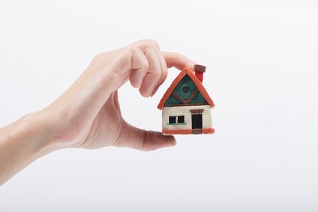 mortgage, investment, real estate and property concept - close up of home model, money and house...