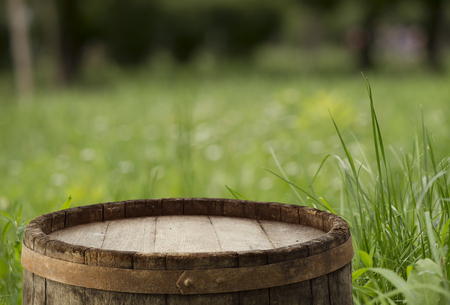 Wood floor with blurred trees of nature park background and summer season, product display montageの写真素材