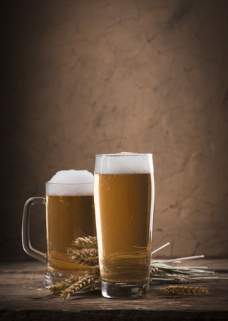 Beer barrel with beer glass on table on wooden backgroundの写真素材