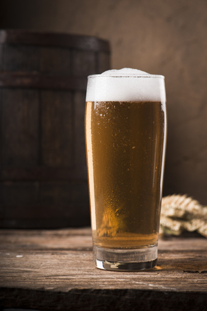 Beer barrel with beer glass on table on wooden backgroundの写真素材