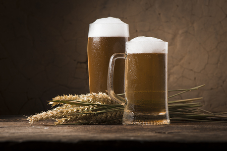 Beer barrel with beer glass on table on wooden backgroundの写真素材