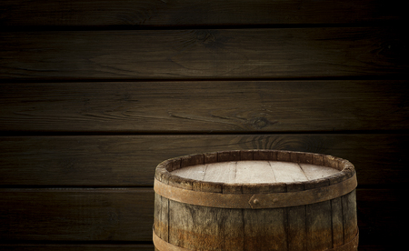 background of barrel and worn old table of woodの写真素材