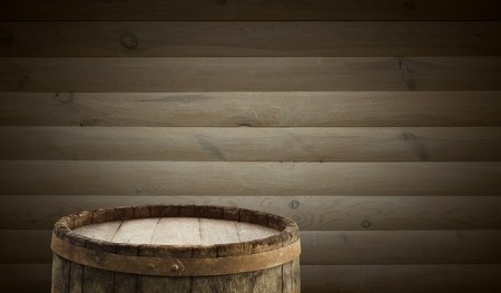 background of barrel and worn old table of woodの写真素材