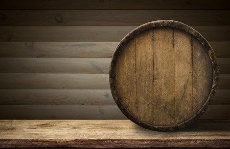 background of barrel and worn old table of wood.の写真素材