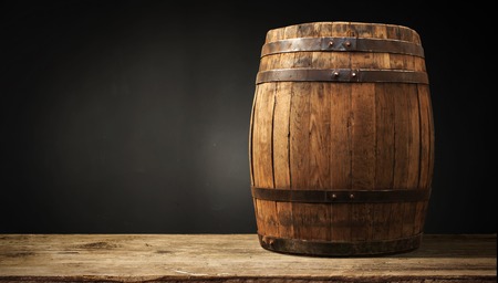 background of barrel and worn old table of woodの写真素材