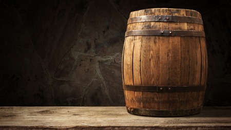 background of barrel and worn old table of woodの写真素材