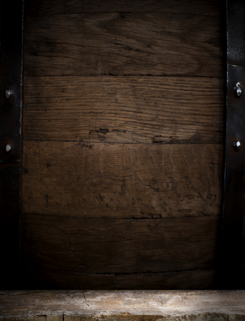 background of barrel and worn old table of woodの写真素材