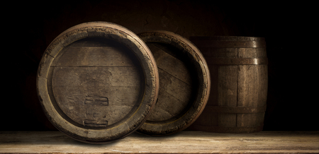 background of barrel and worn old table of woodの写真素材