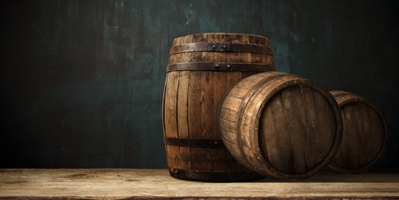 background of barrel and worn old table of woodの写真素材