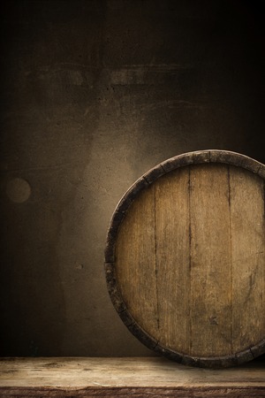 background of barrel and worn old table of woodの写真素材