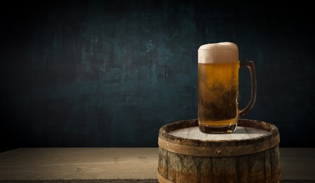 background barrel and worn old table of woodの写真素材