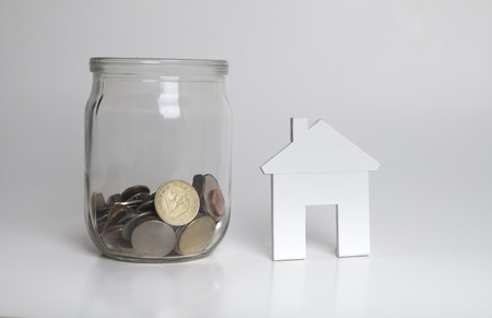 red model of house as symbol on sunny backgroundの写真素材