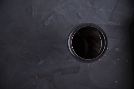 Red wine glasses and bottle on stone background. Top view with copy spaceの写真素材