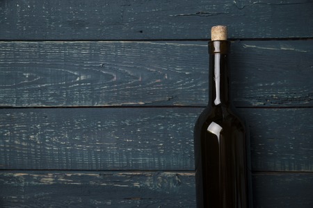 Red wine glasses and bottle on stone background. Top view with copy spaceの写真素材