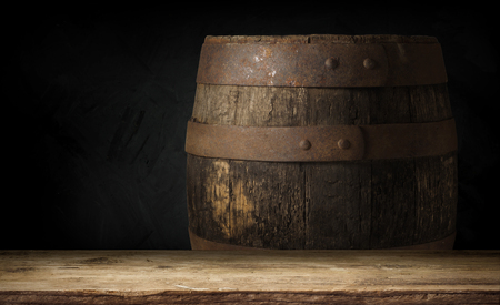 Beer barrel with beer glass on table on wooden backgroundの写真素材