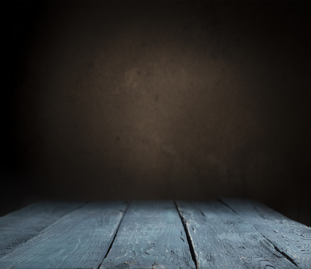 Old wood table top with smoke in the dark background.
