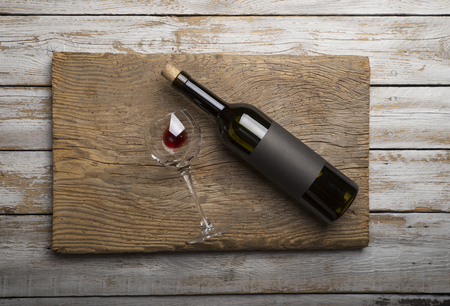 Bottle of red wine with a corkscrew. On a black wooden backgroundの写真素材