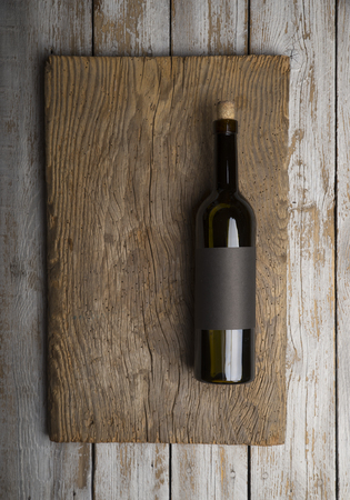 Bottle of red wine with a corkscrew. On a black wooden backgroundの写真素材