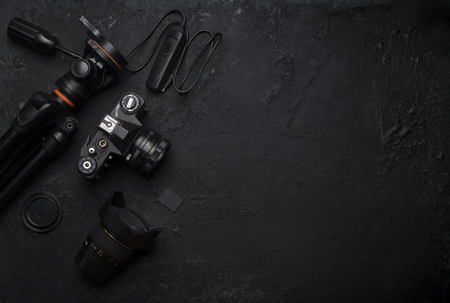 Retro camera on wood table background, vintage color tone. top view with copy space for use.の写真素材