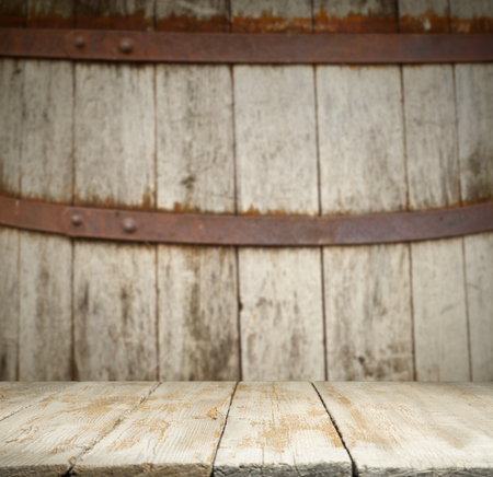 background of barrel and worn old table of wood.の写真素材
