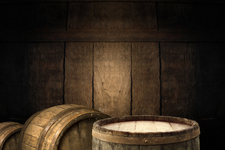 background of barrel and worn old table of wood.の写真素材