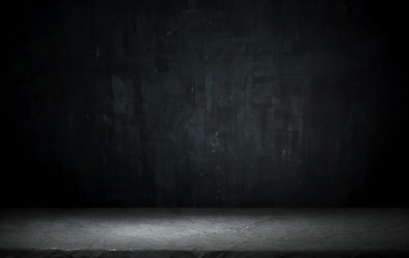 Dark room with tile floor and brick wall background.の写真素材
