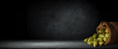 Beer in mug on wooden table near brick wall.の写真素材