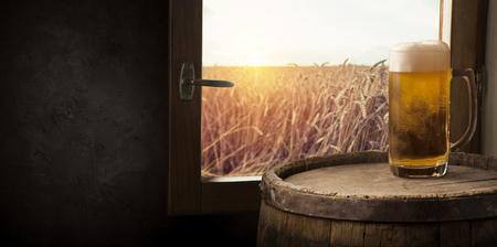 Beer barrel with beer glasses on table on wooden backgroundの写真素材