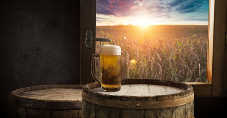 Beer barrel with beer glasses on table on wooden backgroundの写真素材