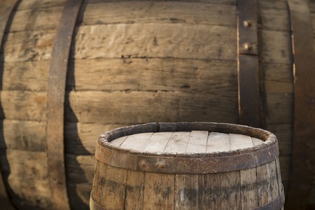 background of barrel and worn old table of wood.の写真素材