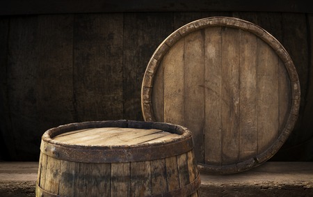 background of barrel and worn old table of wood.の写真素材