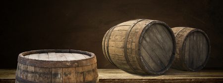 background of barrel and worn old table of woodの写真素材