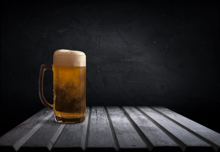 mug of beer on dark background