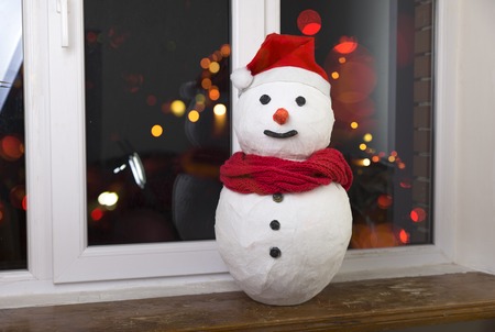 Christmas background with Christmas tree and snowman on a rustic wooden boardの写真素材