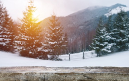 xmas winter blurred background in blue color and shabby wooden table placeの写真素材