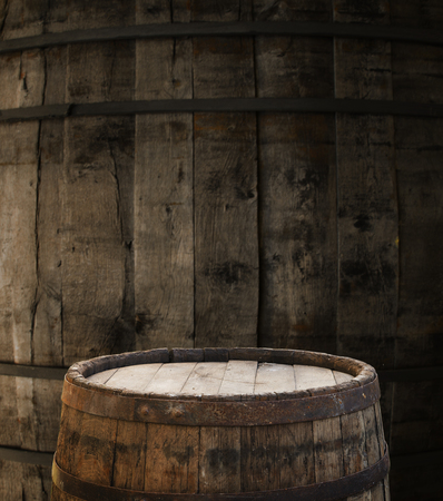 background of barrel and worn old table of woodの写真素材