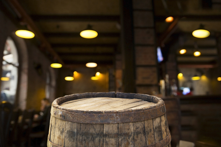 Beer barrel with beer glasses on a wooden table. The dark brown background.の写真素材