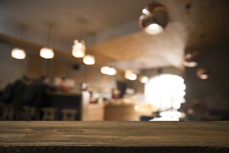 blurred background of bar and dark brown desk space of retro woodの写真素材