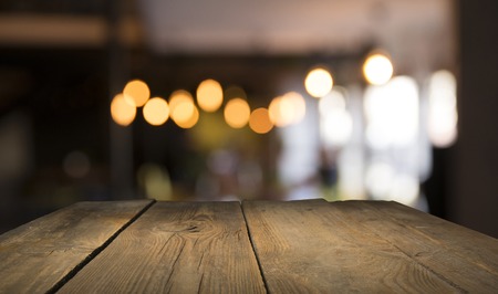 blurred background of bar and dark brown desk space of retro wood